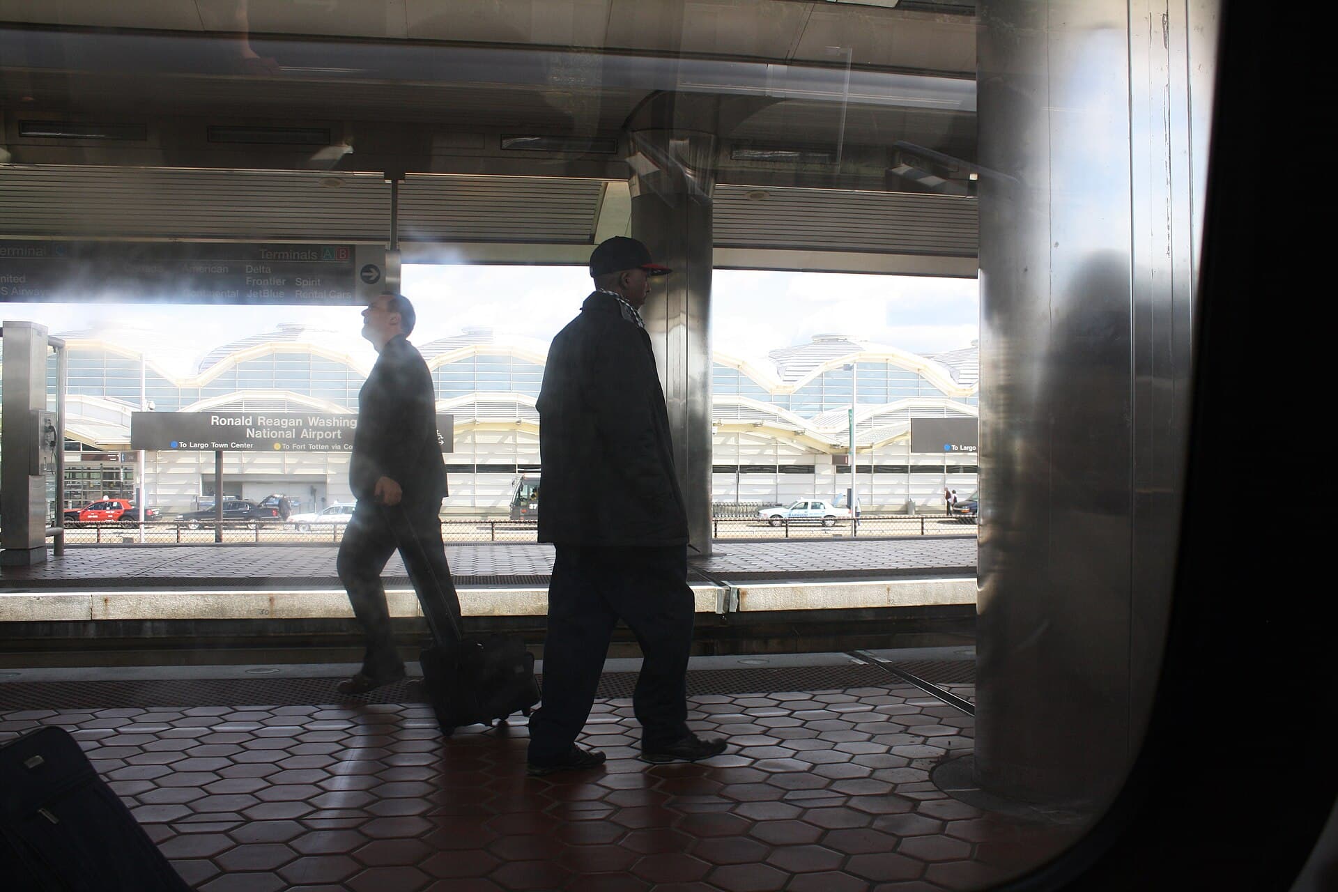 Metro train arriving at the elevated Ronald Reagan Washington National Airport station beside the terminal