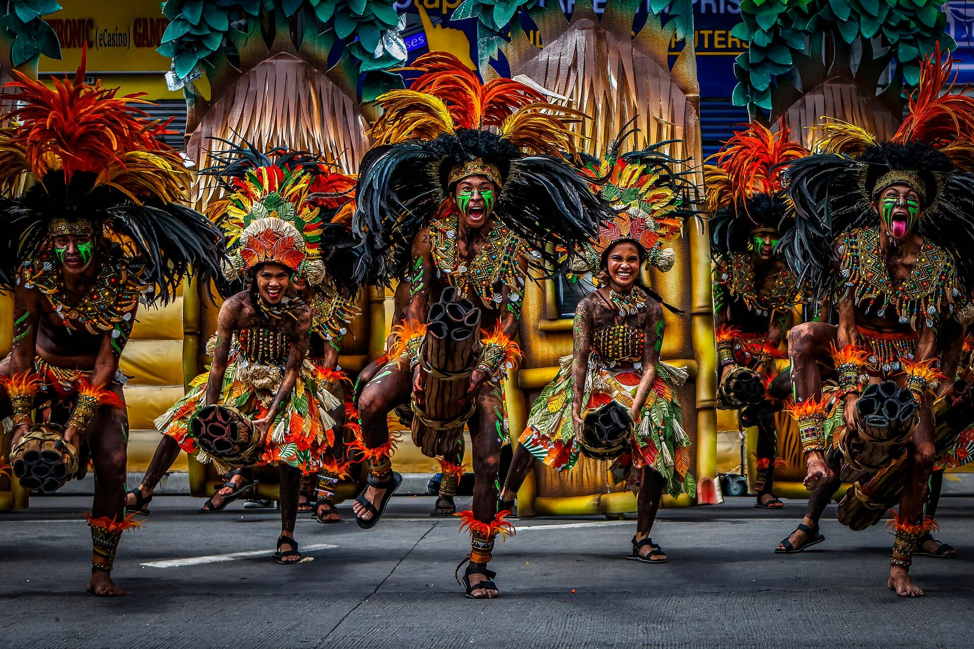 Dinagyang Ati tribe warriors in black body paint and feathered headdresses performing at the Iloilo Freedom Grandstand, Iloilo City
