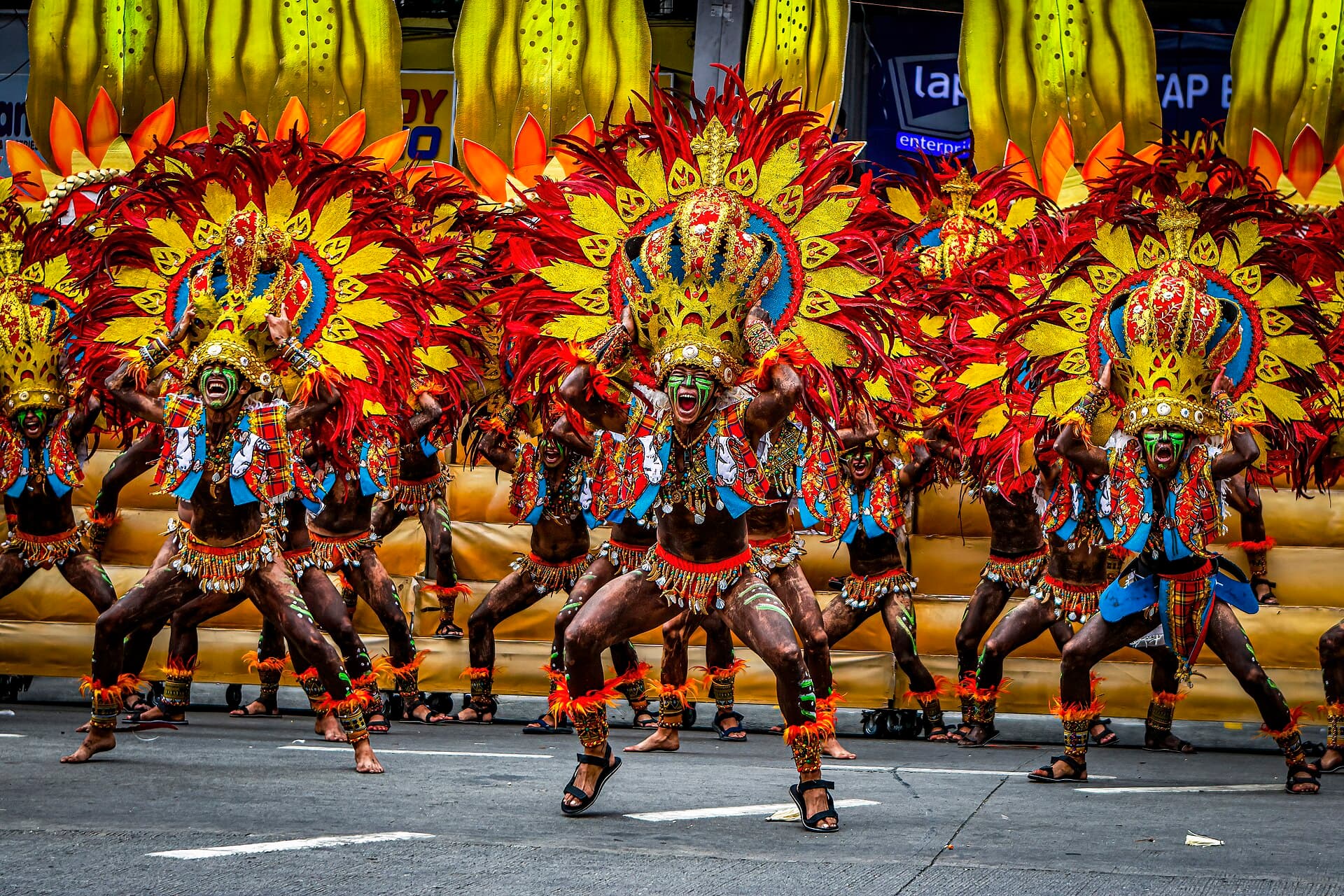 Spectators in the covered stands of the Iloilo Freedom Grandstand on Muelle Loney watching a Dinagyang tribe perform
