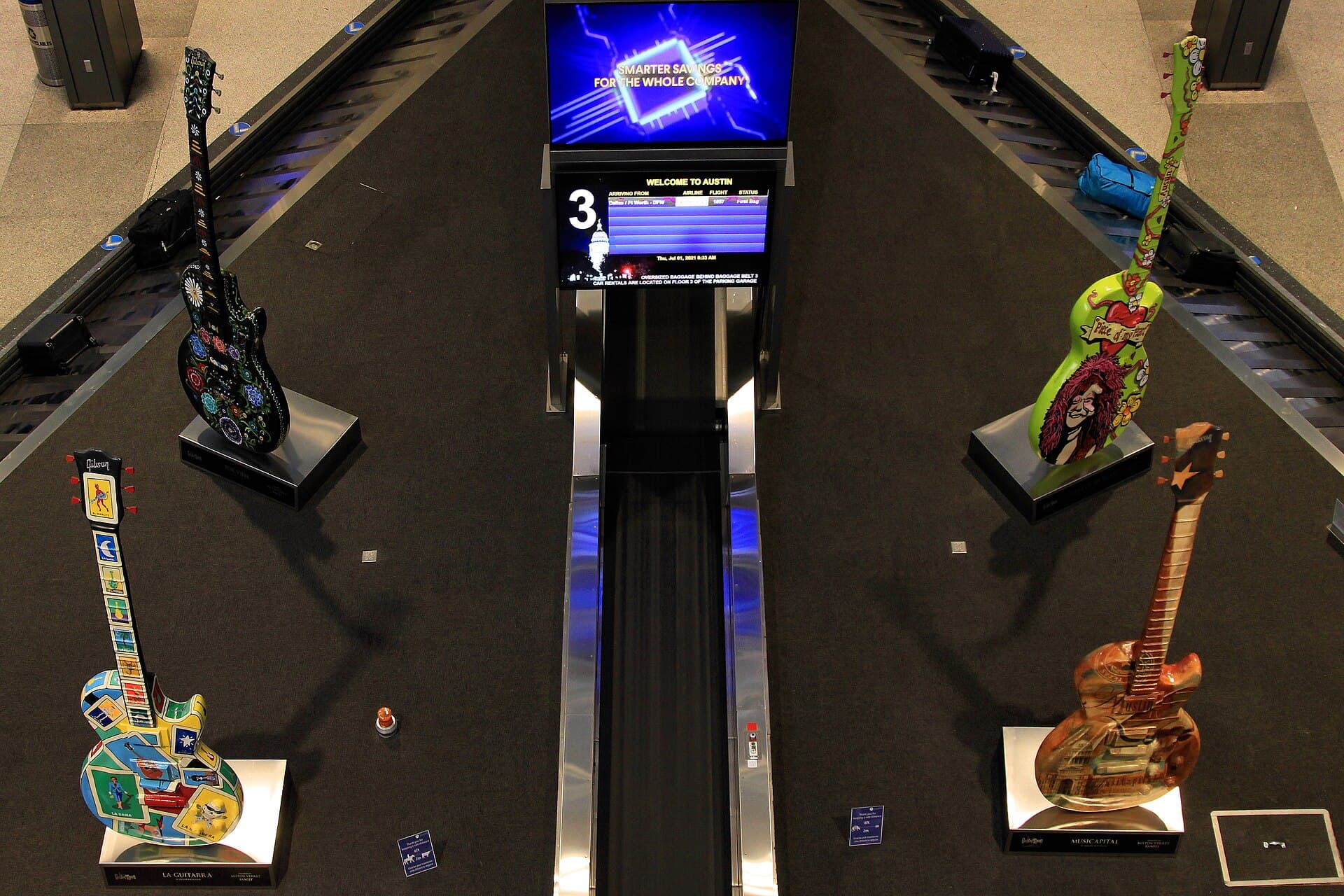 The neon guitar bus stop outside baggage claim at Austin-Bergstrom International Airport