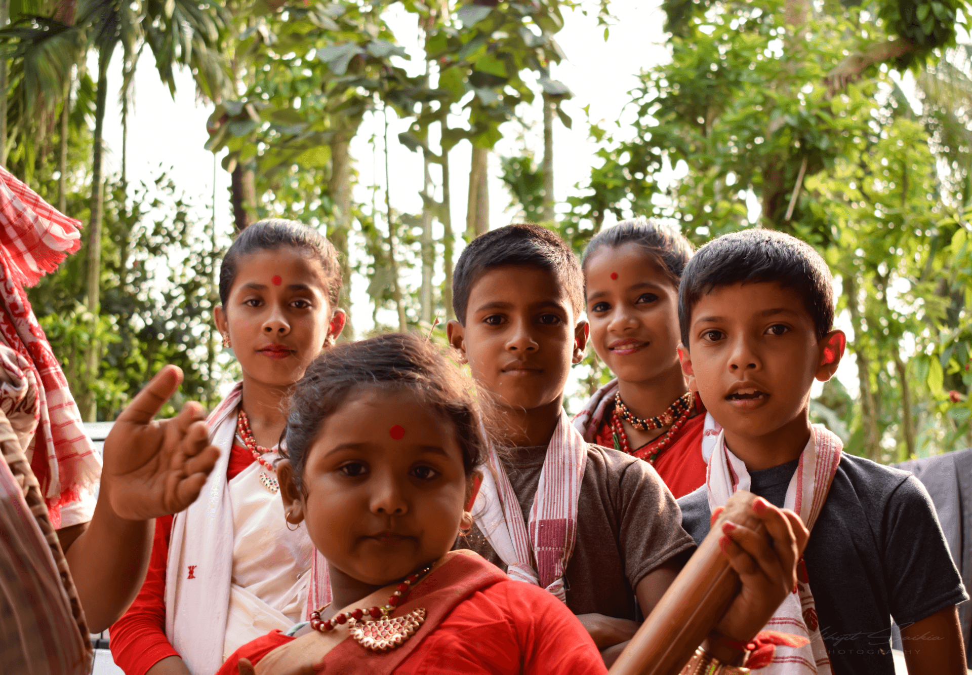 A husori group singing in the courtyard of an Assamese village house in the evening