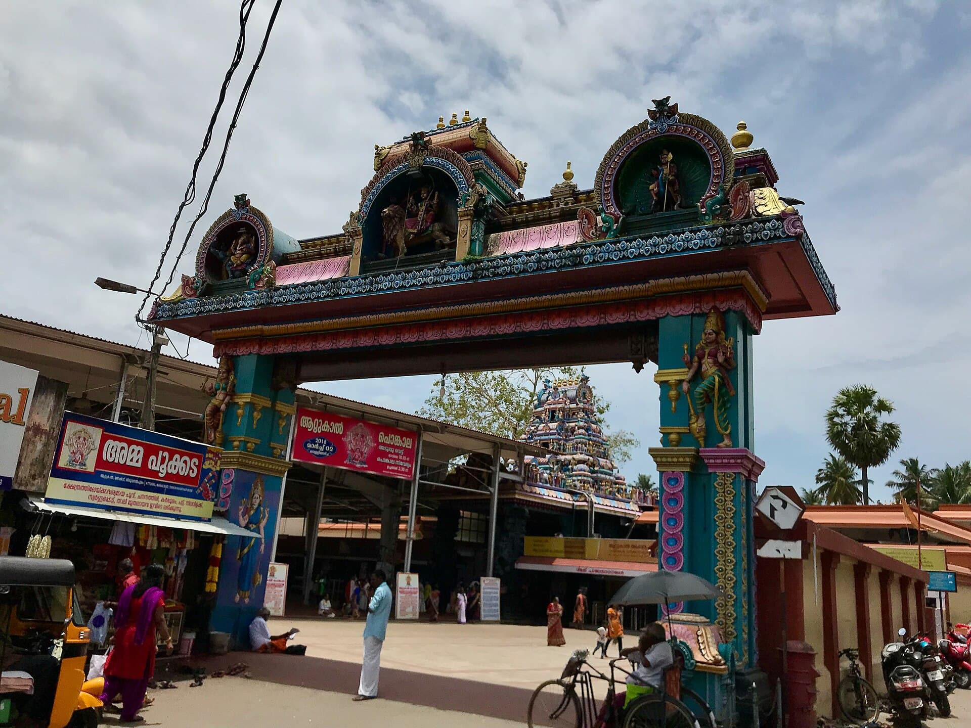 Wide view of brick hearths and clay pots lined along a Thiruvananthapuram street during Attukal Pongala