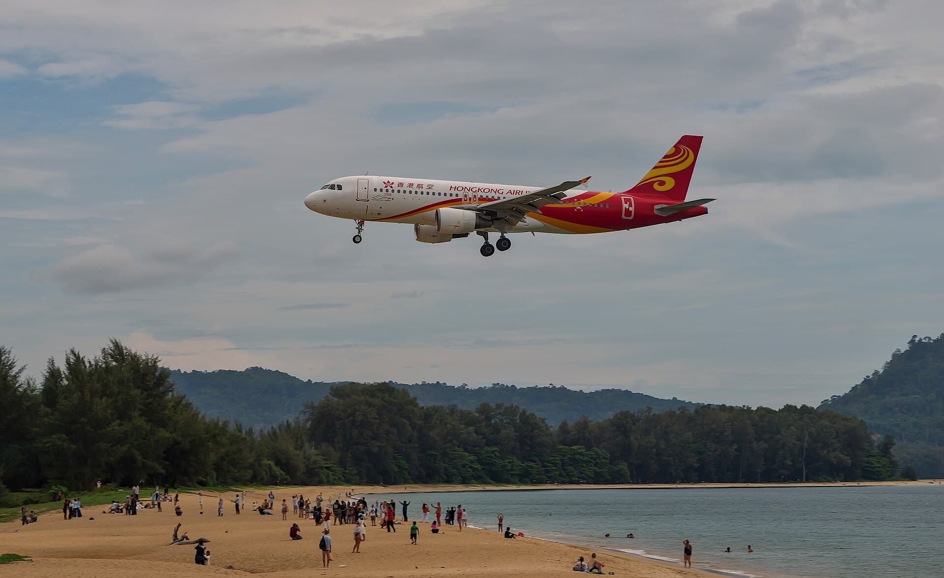 Mai Khao Beach beside Phuket International Airport with a plane landing over the sand