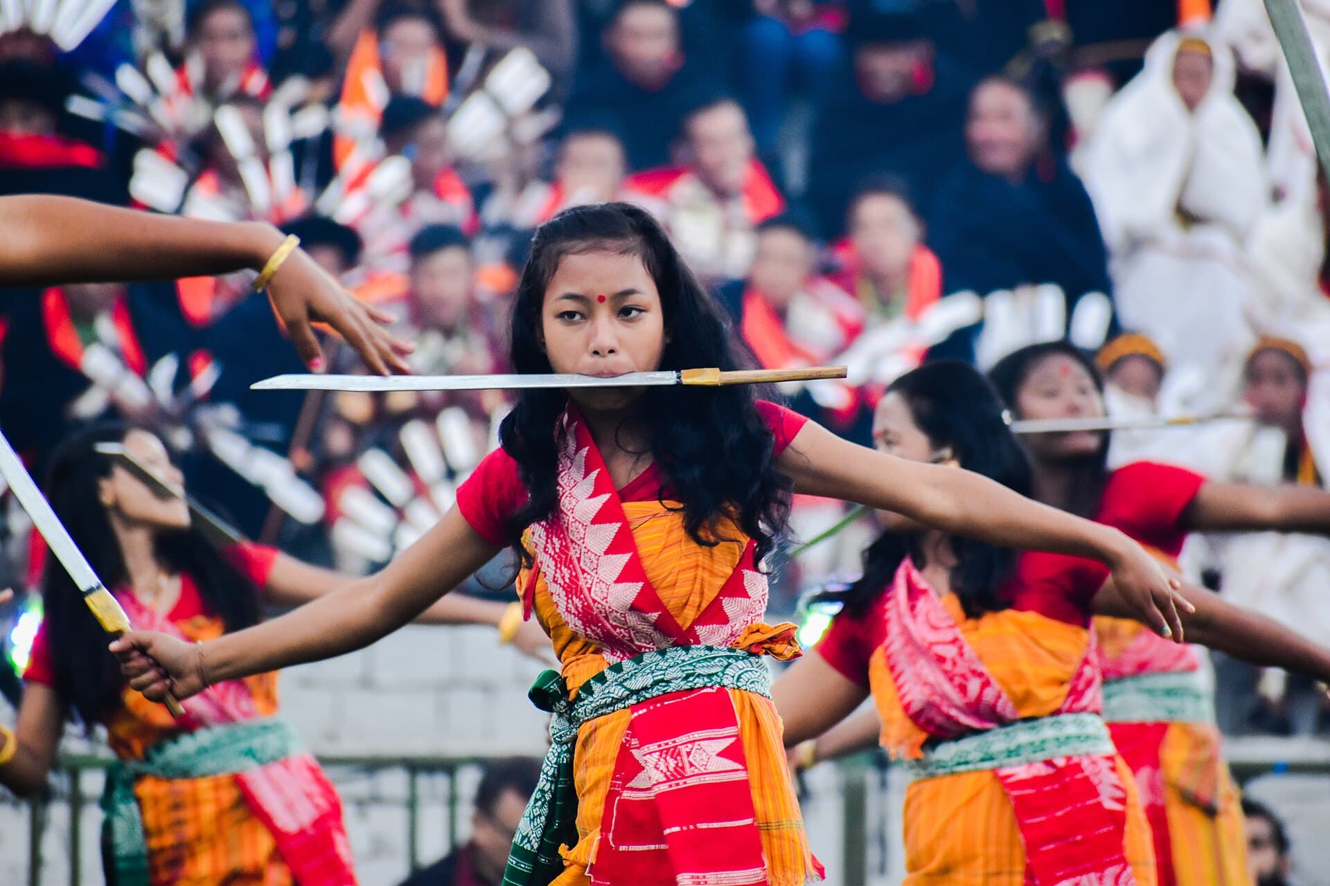 Tribal dancers performing in the main arena at Kisama with the hills behind