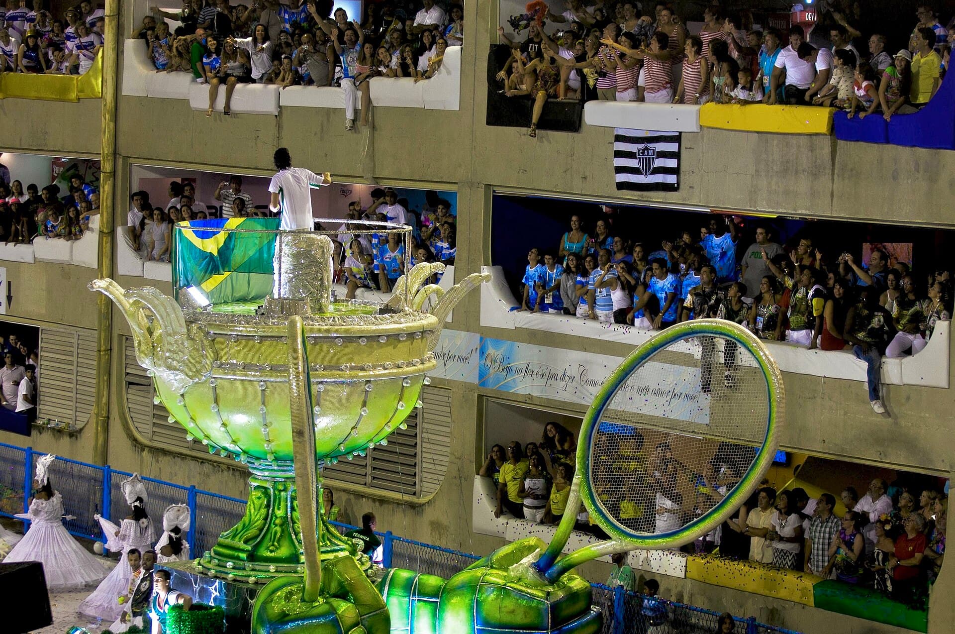 A bateria of drummers entering the Marquês de Sapucaí avenue under floodlights