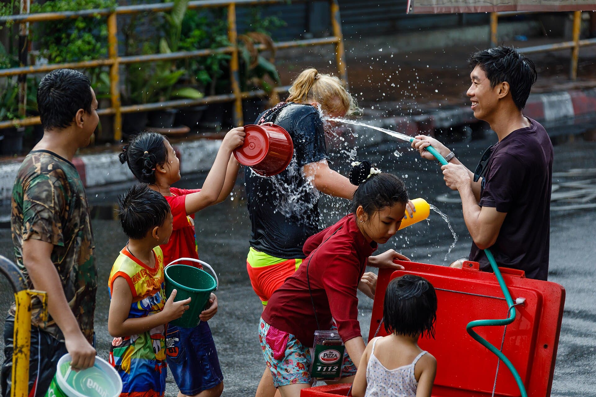 Sand chedis decorated with tung flags in a Chiang Mai temple courtyard at Songkran