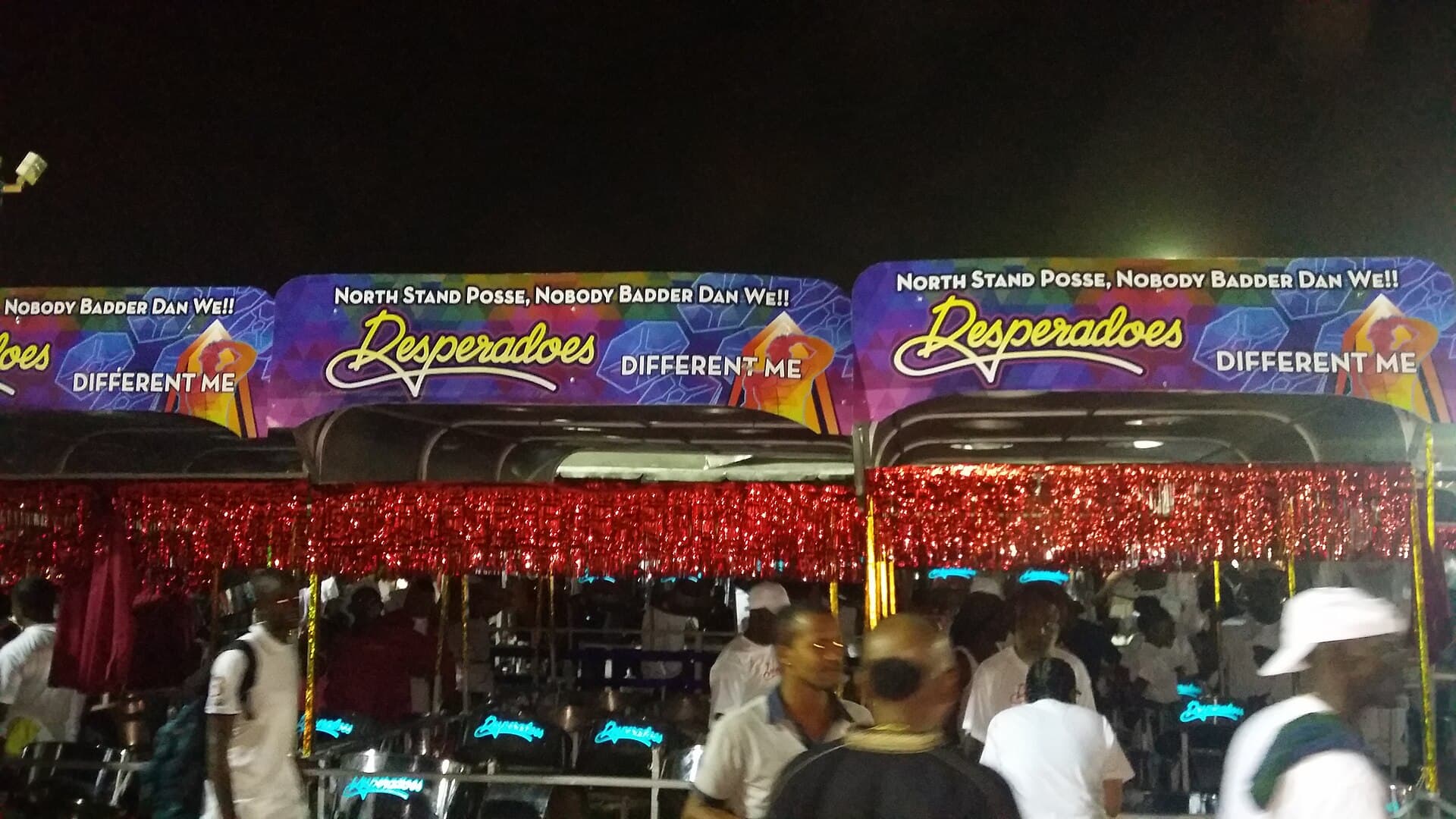 A large steelband playing on the Panorama stage at Queen's Park Savannah at night