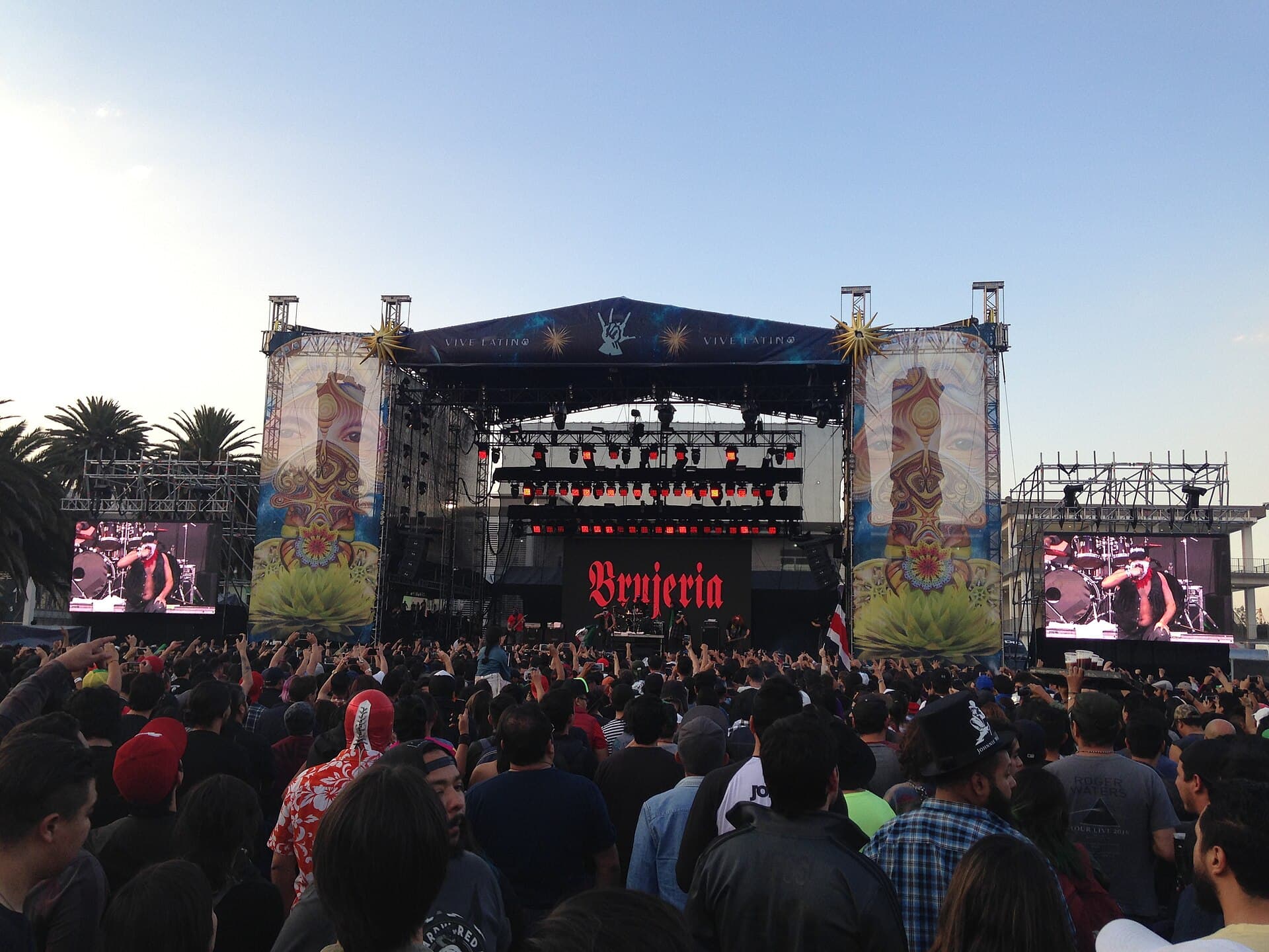 Wide shot of the main stage crowd at Vive Latino at Foro Sol, with stage lights at dusk