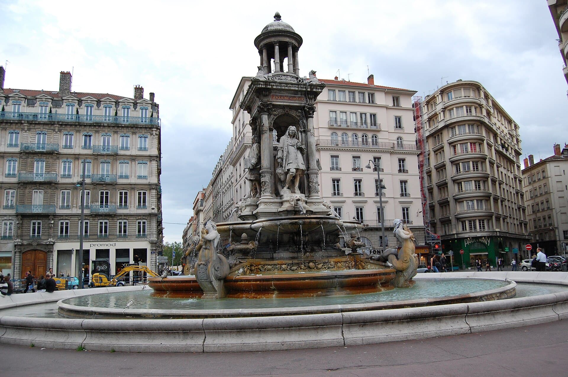 The Place des Jacobins fountain with Lyon's Presqu'île skyline at dusk