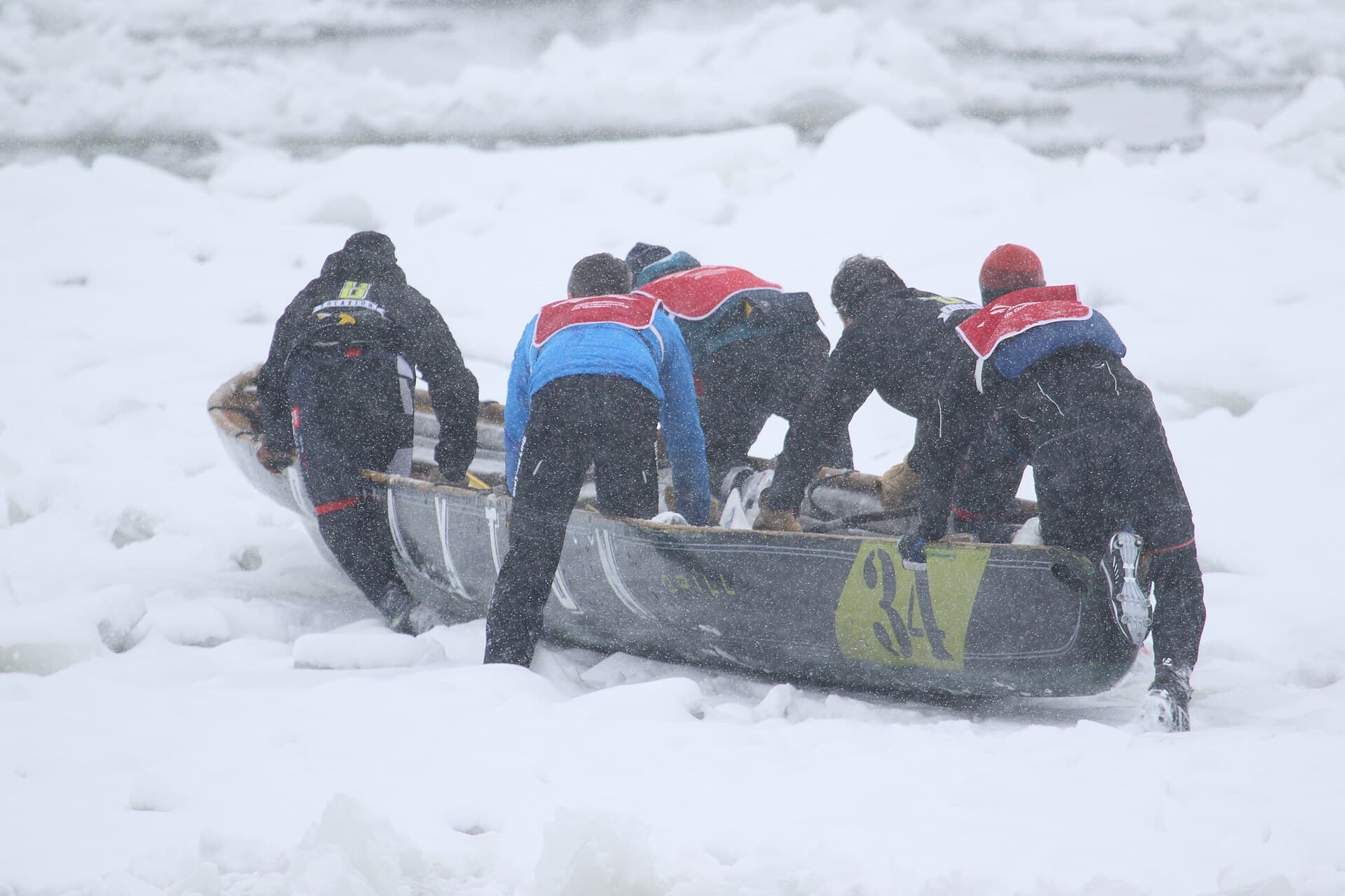 Ice canoe teams racing across the St. Lawrence River with the Château Frontenac behind them