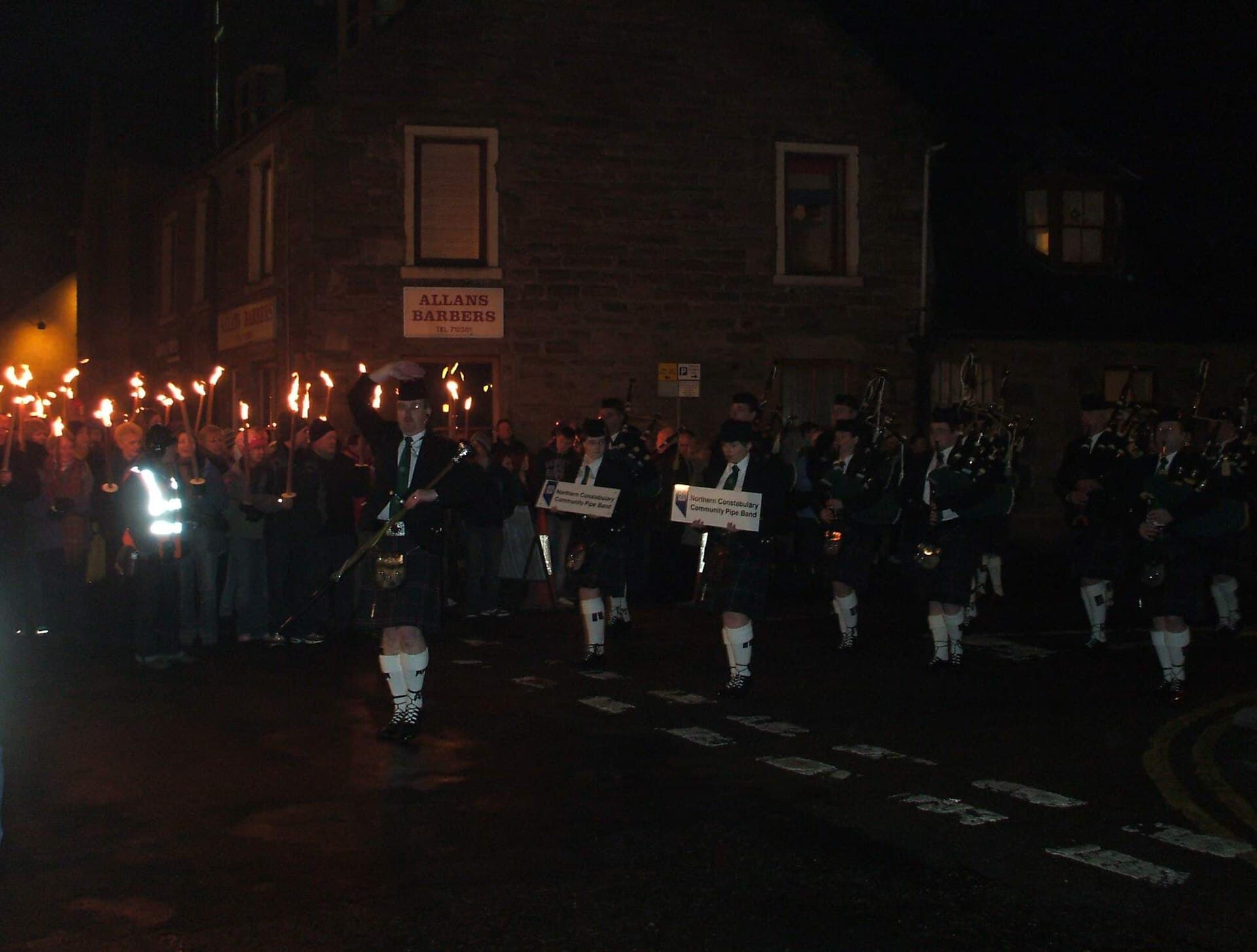 Torchlight Procession of torch bearers walking through the Old Town of Edinburgh