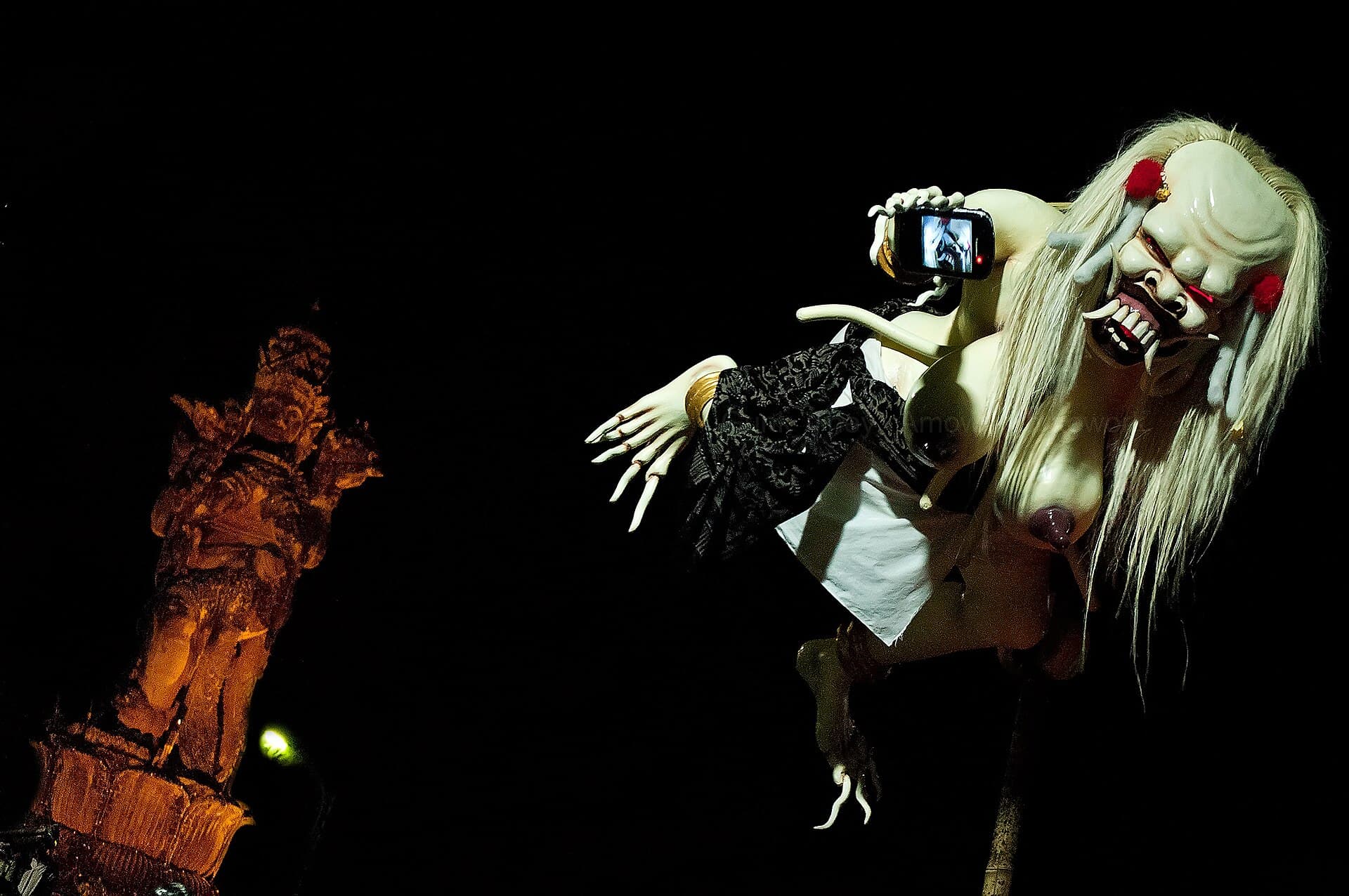 Ogoh-Ogoh demon effigies being carried on bamboo platforms through a Bali street at dusk on Pengrupukan evening