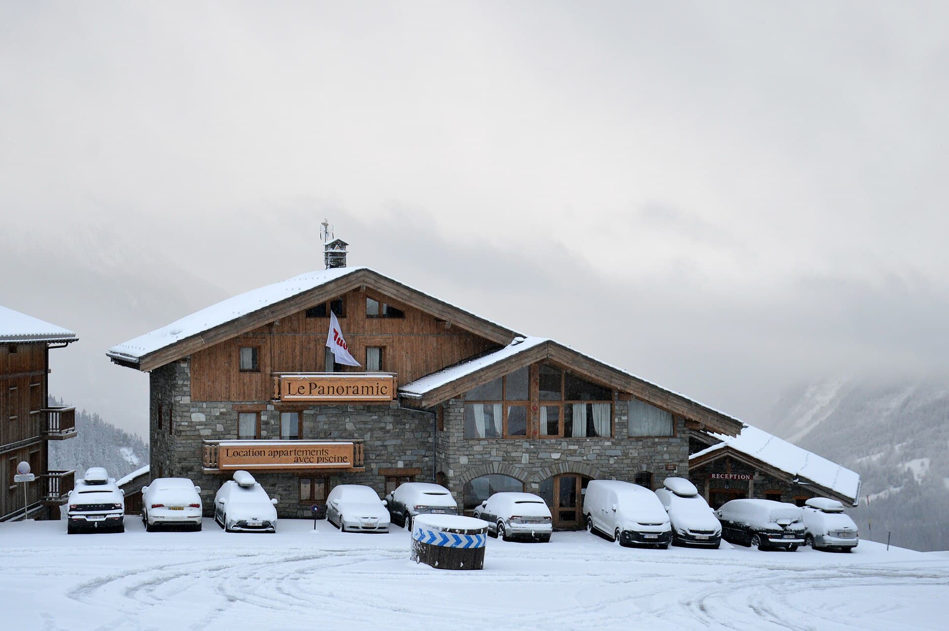 Chalets and apartment buildings along the snow-covered streets of Alpe d'Huez at dusk