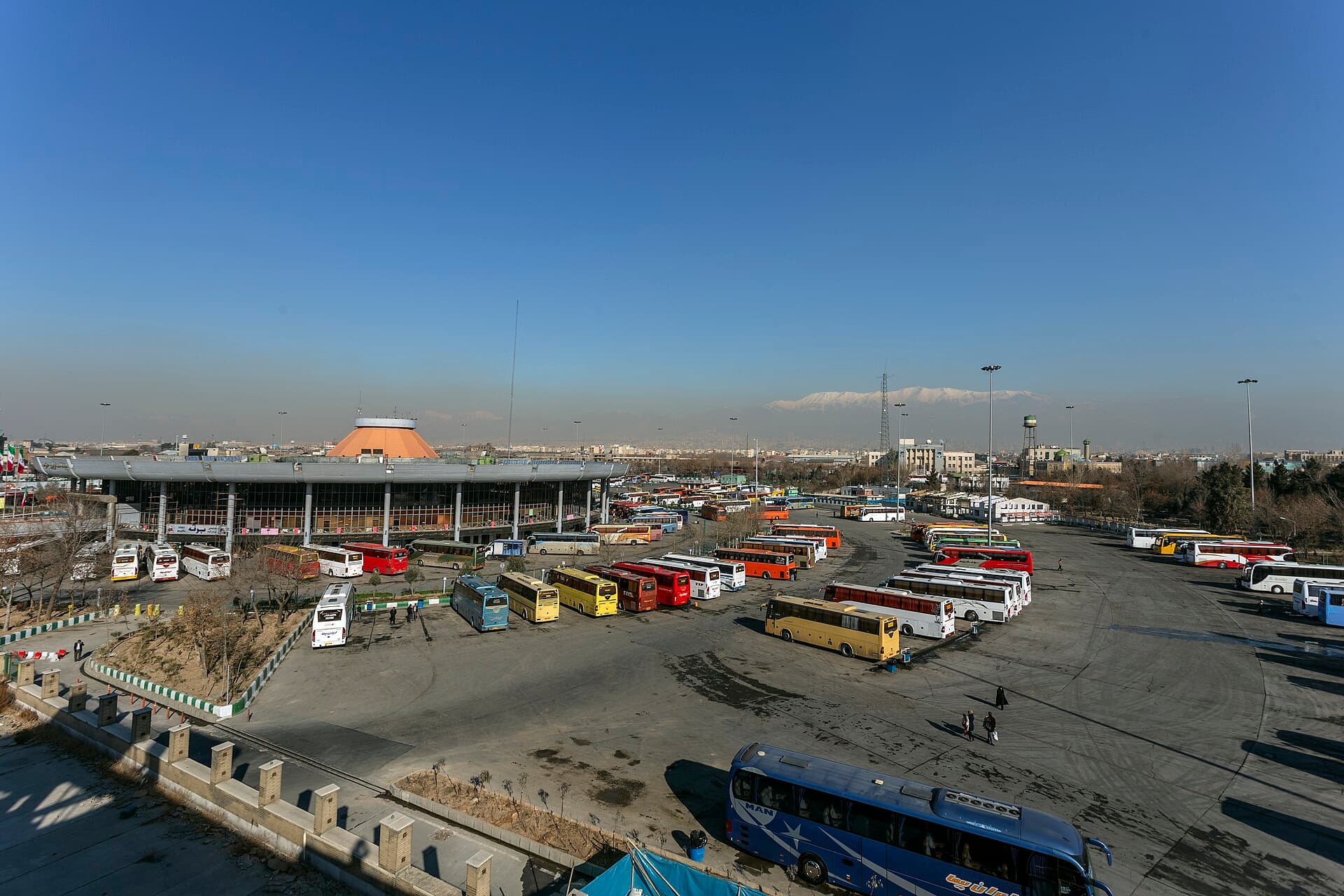 Intercity buses at the Terminal de Ómnibus de Córdoba with passengers boarding