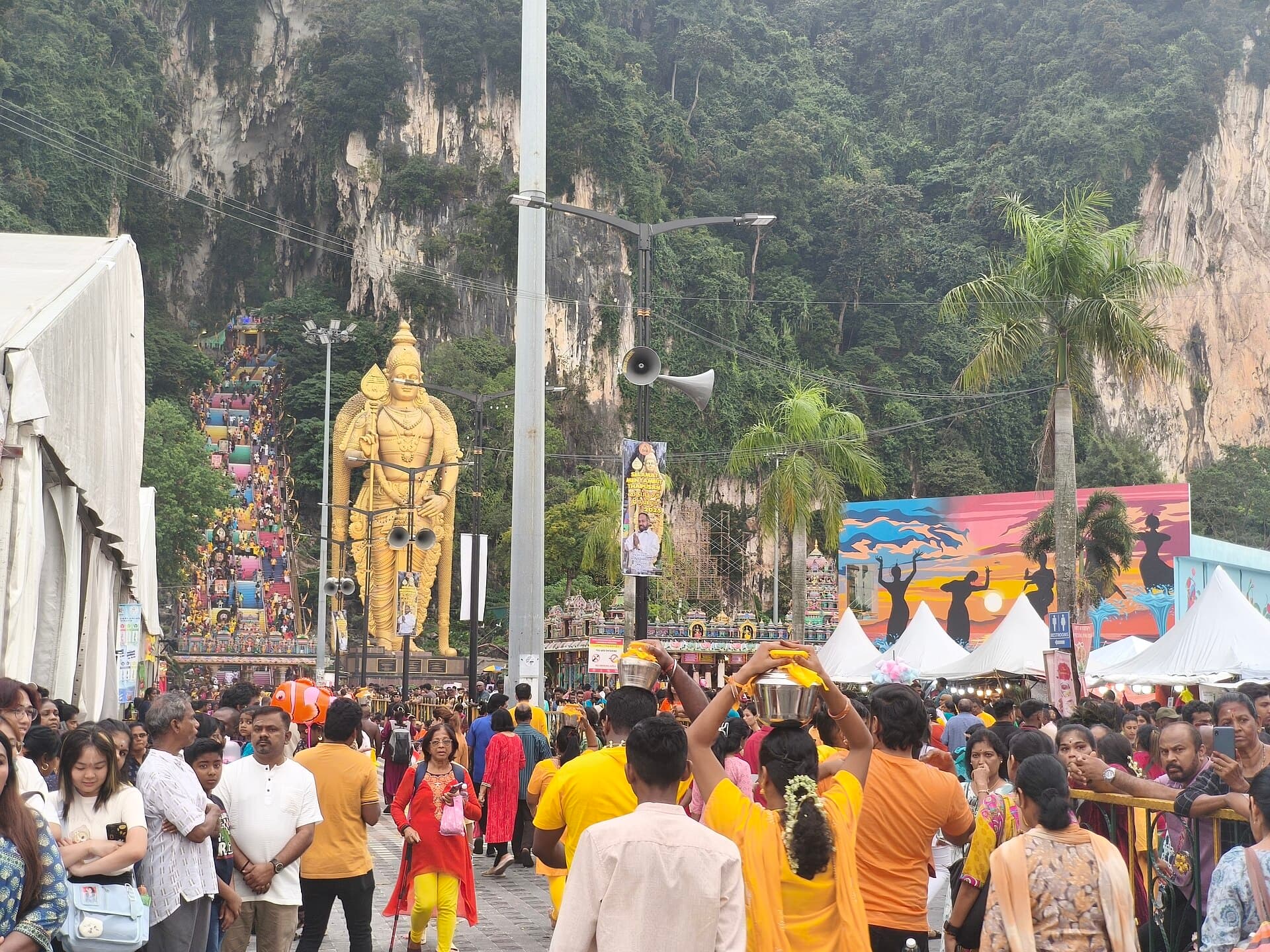 Devotees carrying milk pots (paal kudam) on their heads along the road to Batu Caves