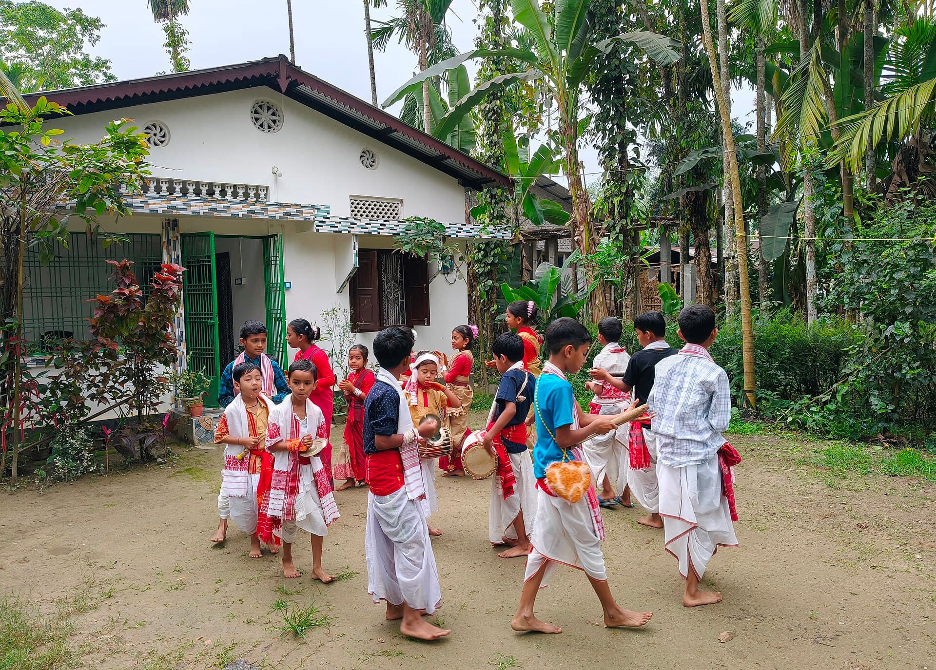 Visitors holding up phones to film the dhol players during an evening Bihu performance