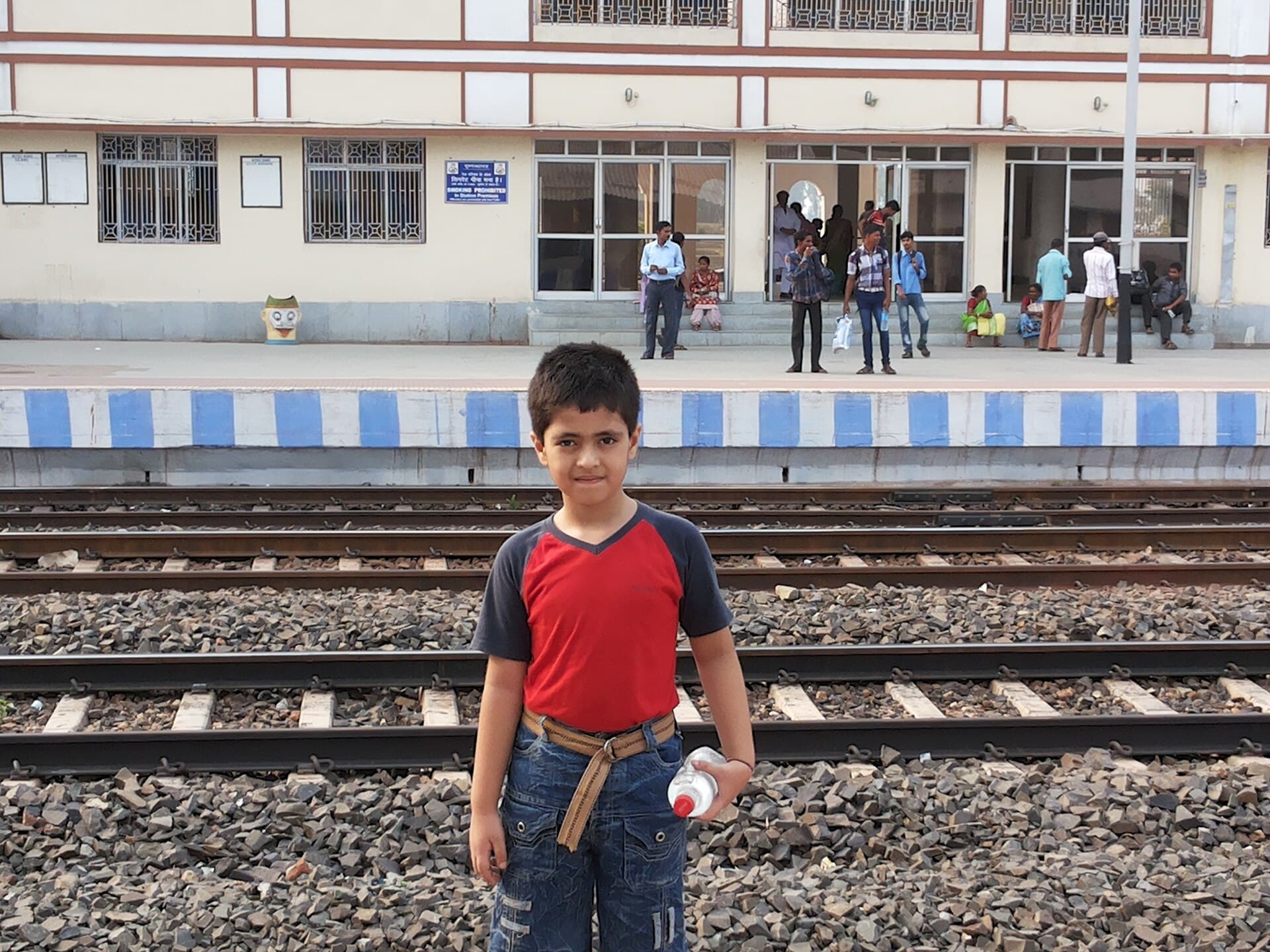 Thrissur Railway Station platform with travellers and a train arriving from Ernakulam