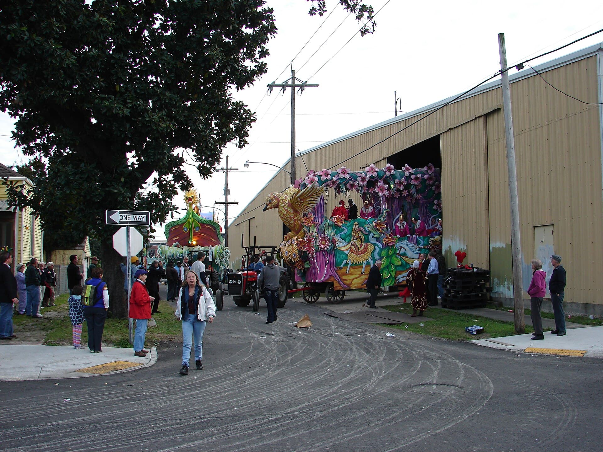Wide view of a lit Krewe of Endymion float rolling down Canal Street at night with crowds lining both sides