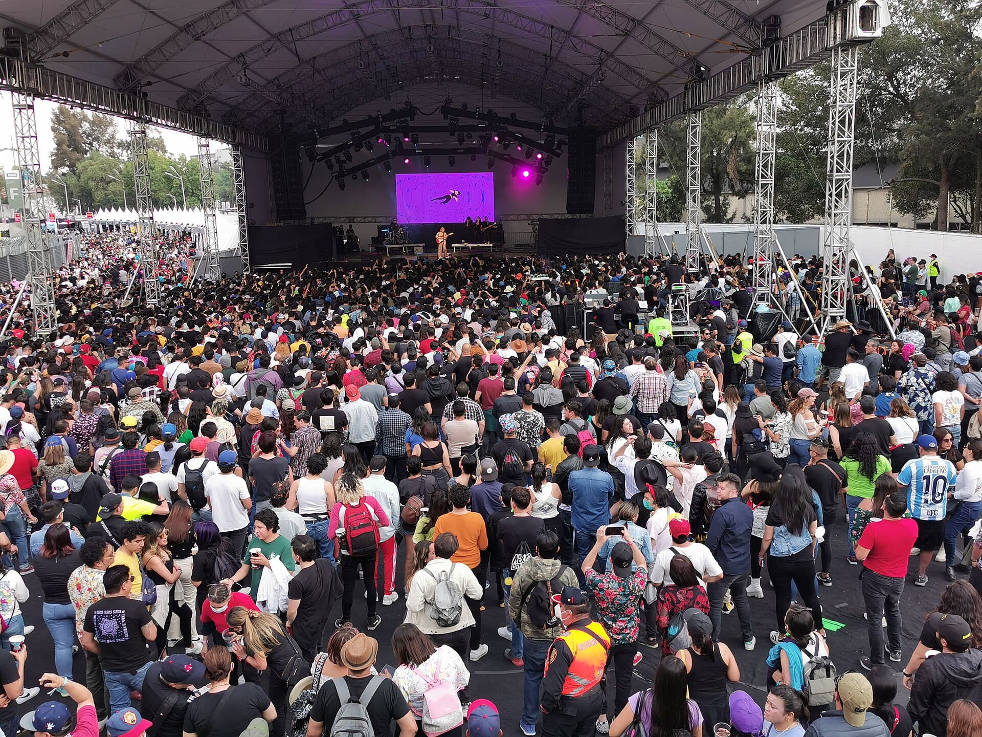 The Telcel stage and the Carpa Intolerante tent at Vive Latino seen from the field during an afternoon set
