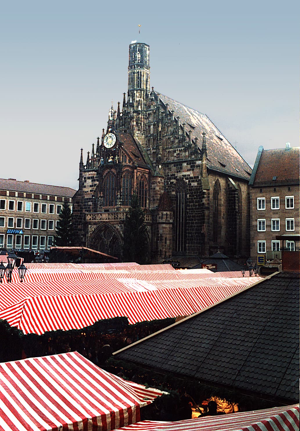 Stalls with red-and-white striped cloth roofs on the Hauptmarkt in Nuremberg during the day