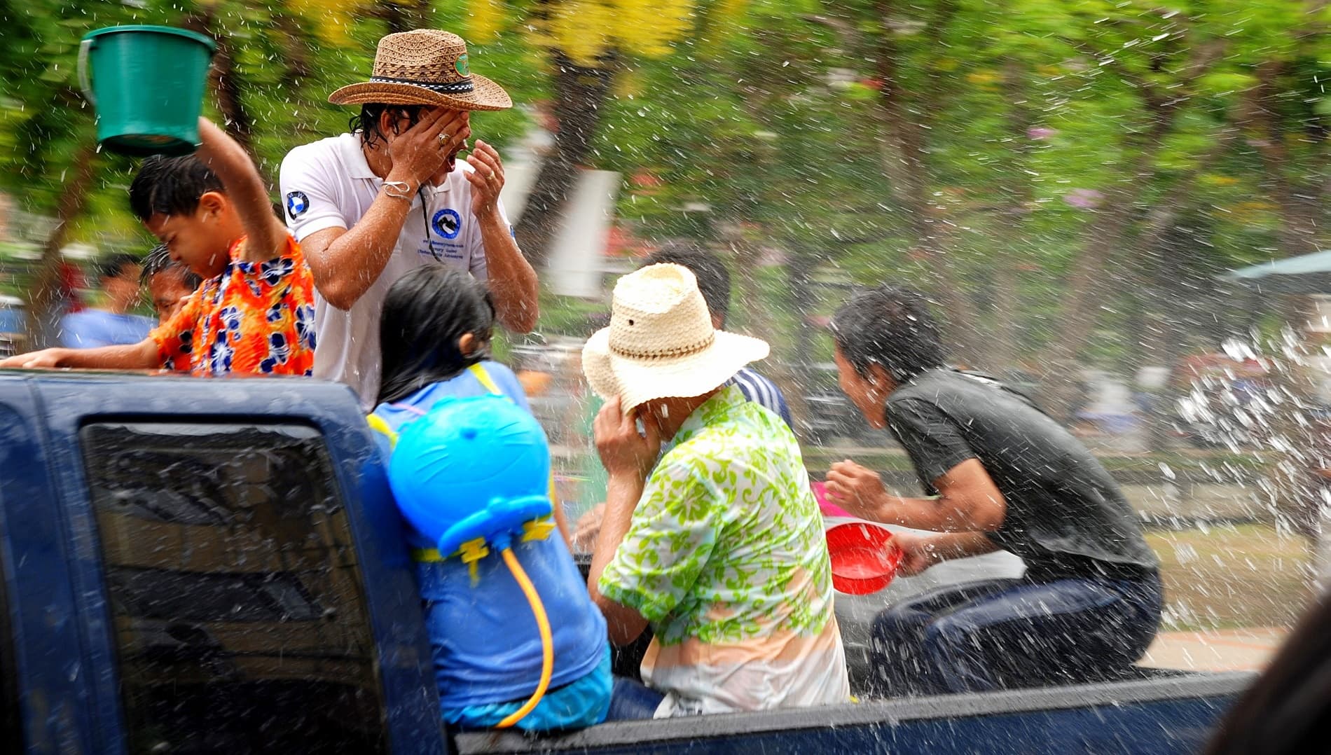 Songkran crowd with phones in waterproof pouches at the Jaeng Sri Phum corner of the Chiang Mai moat