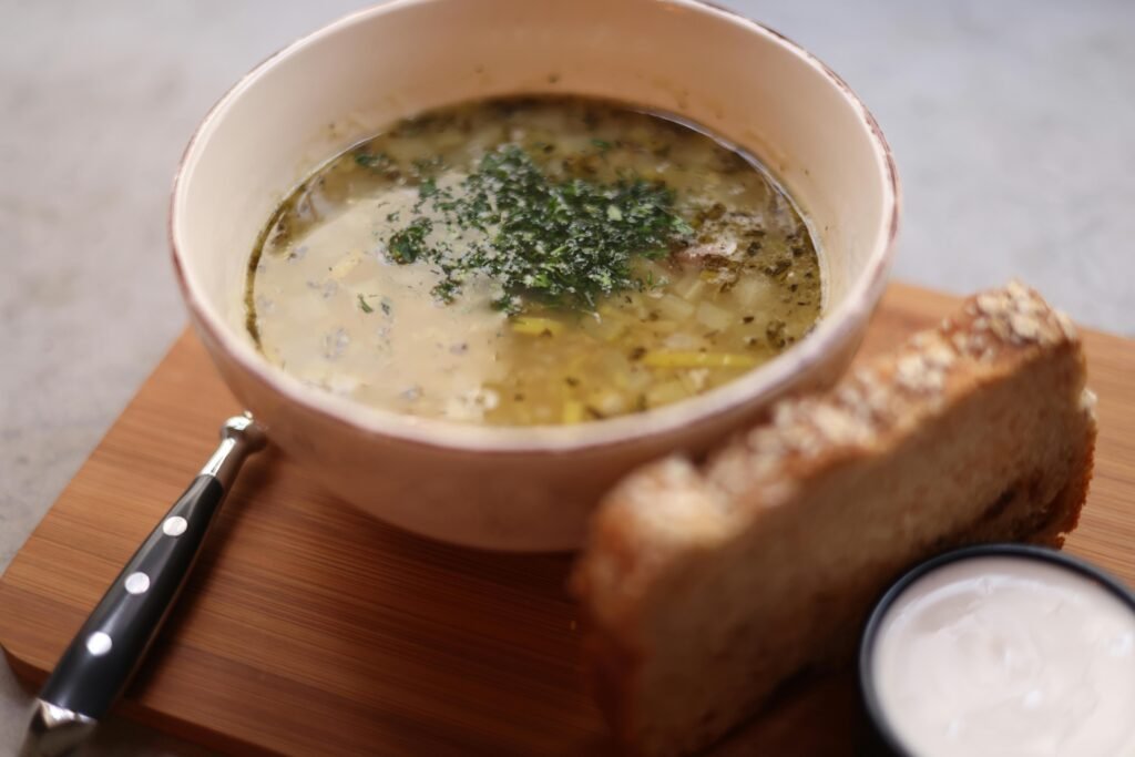 Bowl of French Onion Soup with caramelized onions, broth, topped with a toasted baguette slice and melted Gruyère cheese. Best local food in France