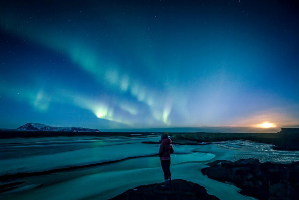 Successful Northern Lights chasers celebrating aurora sighting in Iceland after learning how to chase the Northern Lights in Iceland