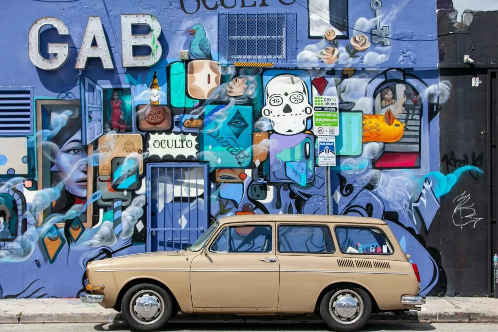 Vibrant Art Deco wall mural on a street in Miami, showcasing bold colors and geometric designs reflecting the city’s iconic architectural style