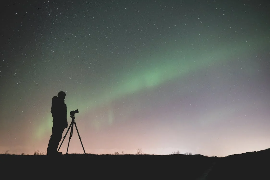 Photographing Northern Lights in Iceland with proper camera setup, essential for how to chase the Northern Lights in Iceland