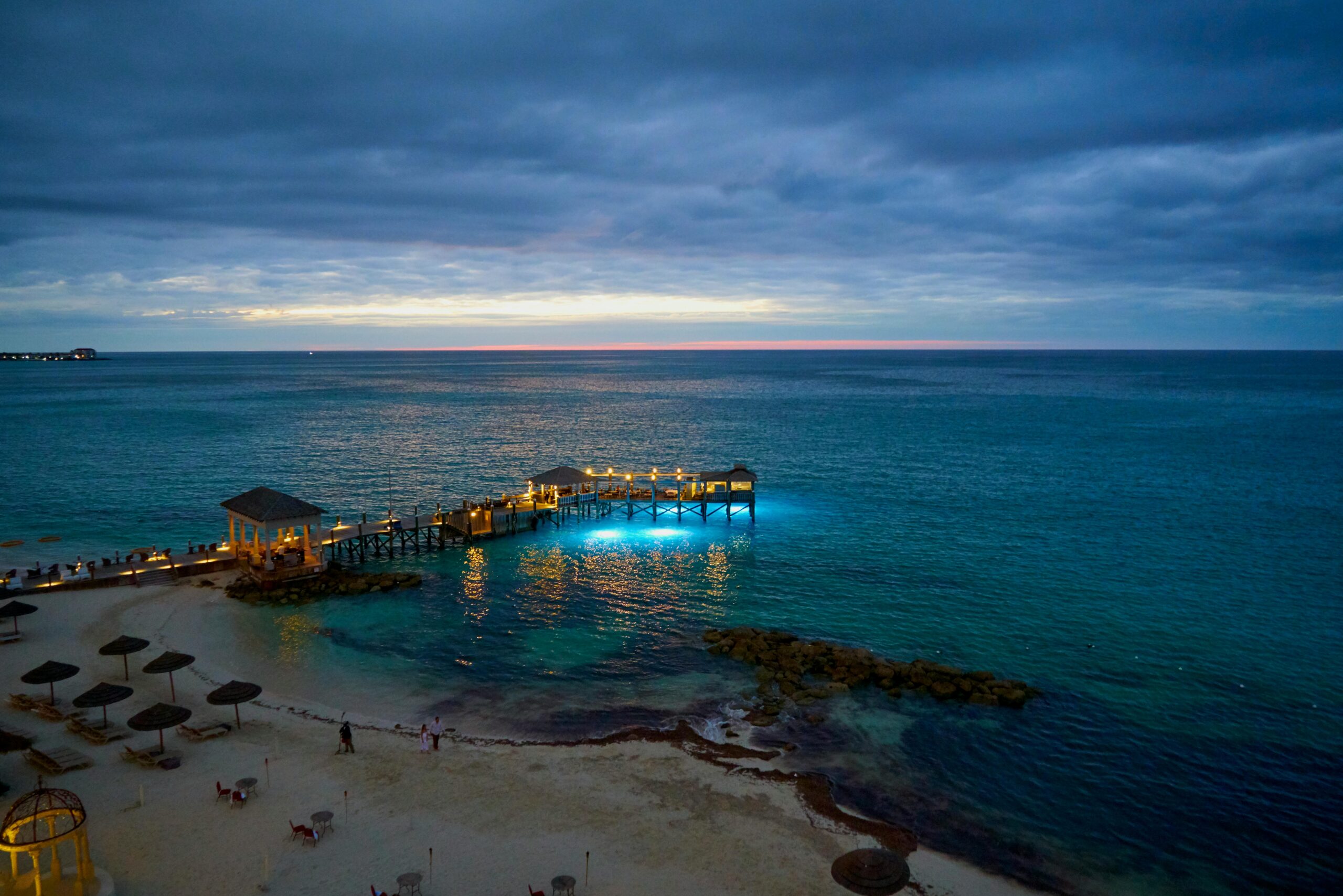 Stunning ocean view at dawn with overwater bungalows reflecting on the calm waters