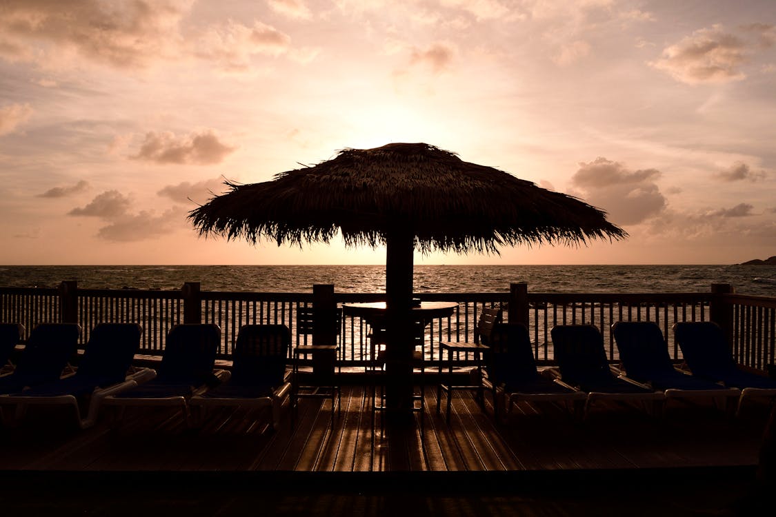 Breathtaking sunset view from a beach in Saint Lucia, with golden skies reflecting on the calm Caribbean waters