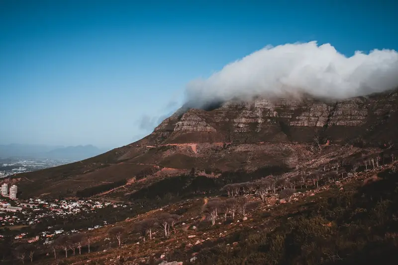 Panoramic view of Cape Town from Table Mountain covered in clouds