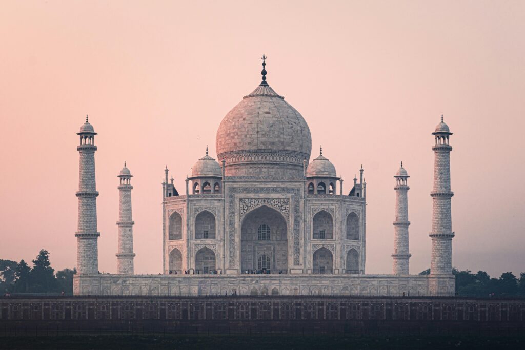 the iconic Taj Mahal reflecting in its pools at sunrise, one of the best places to visit in India
