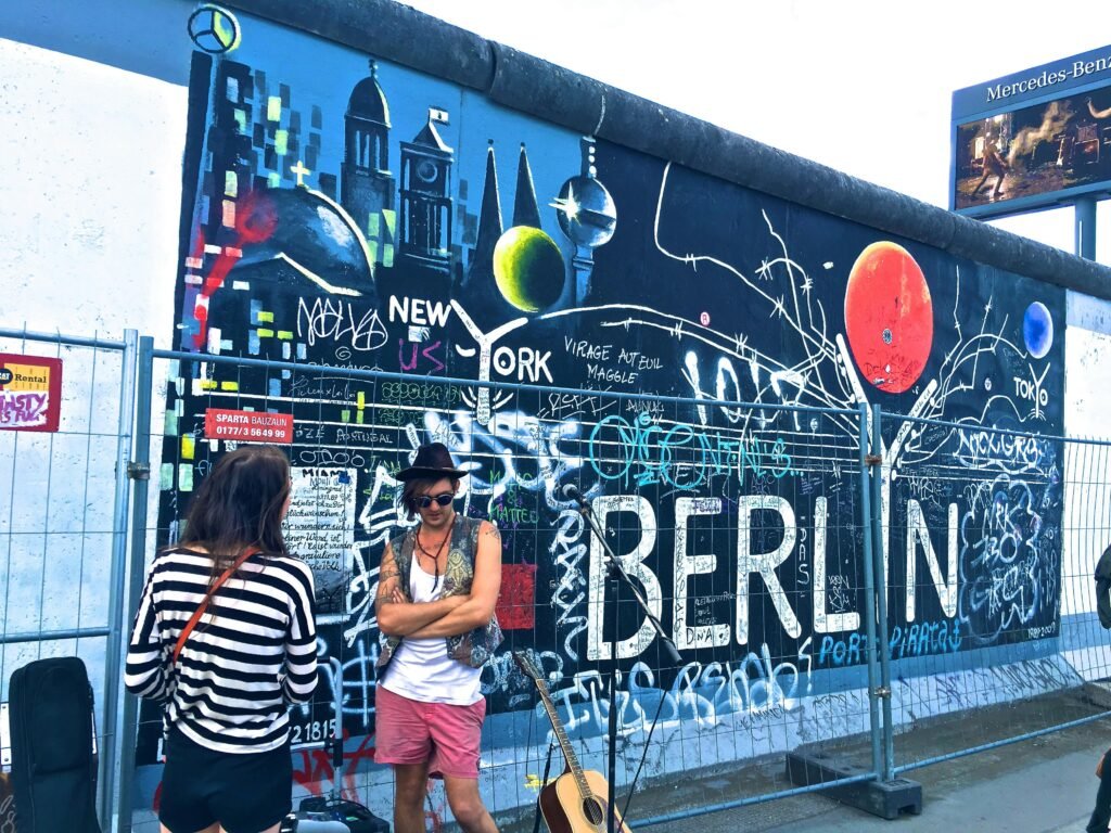 Historical murals on Berlin Wall at East Side Gallery - iconic street art scenes in Berlin