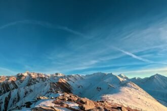 Snow-covered Tien Shan mountains in Almaty Region during winter, showcasing dramatic peaks and frosty alpine landscapes
