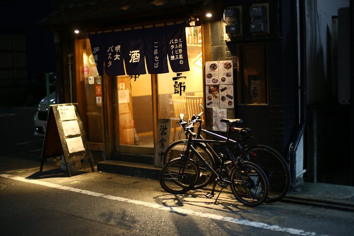Traveler enjoying a traditional Japanese meal at a local restaurant, highlighting the best places to visit in Japan for culinary experiences